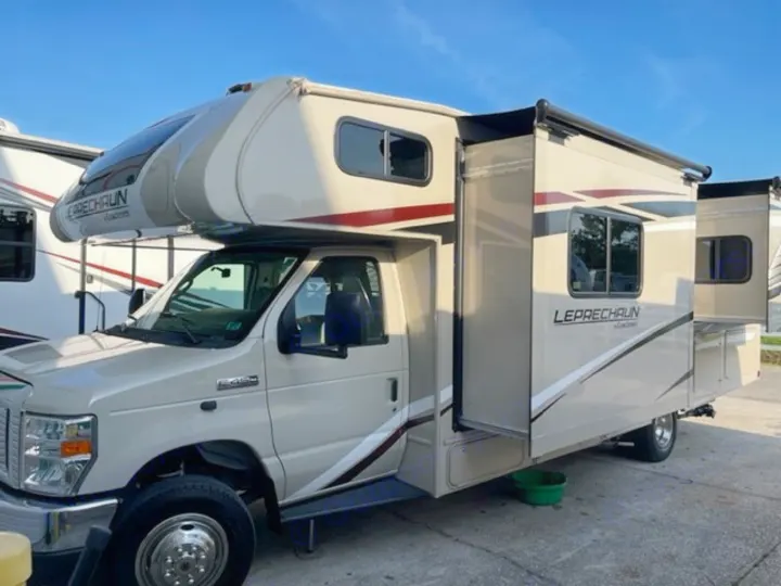 A beige Class C Leprechaun RV is shown with its slide-out extended, ideal for an rv rental adventure.. COACHMEN LEPRECHAUN 2021