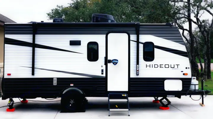A white & black travel trailer, branded "Hideout", perfect for your next rv rental or camping adventure.. Keystone RV Hideout 2021