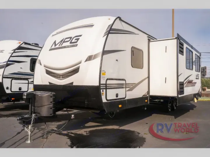A modern white MPG Ultra-Lite travel trailer, with its slide-out extended, is ready for your RV rental.. Cruiser RV MPG Ultra Lite 2022