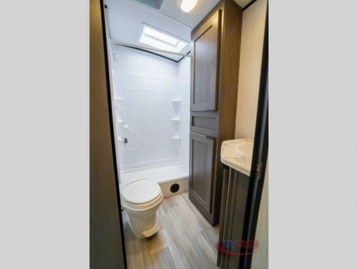 Experience comfort in this RV rental bathroom. Features a compact shower, toilet, sink vanity, and storage cabinet.. Cruiser RV MPG Ultra Lite 2022