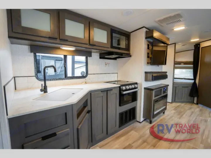 Spacious RV rental interior: A modern kitchen with appliances, entertainment area, and rear bedroom.. Cruiser RV MPG Ultra Lite 2022