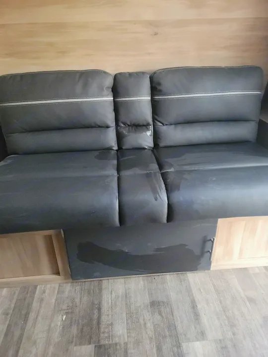 RV rental interior: Gray bench seating with visible water stains. Light wood wall panels and laminate floor.. Coachmen Other 2021
