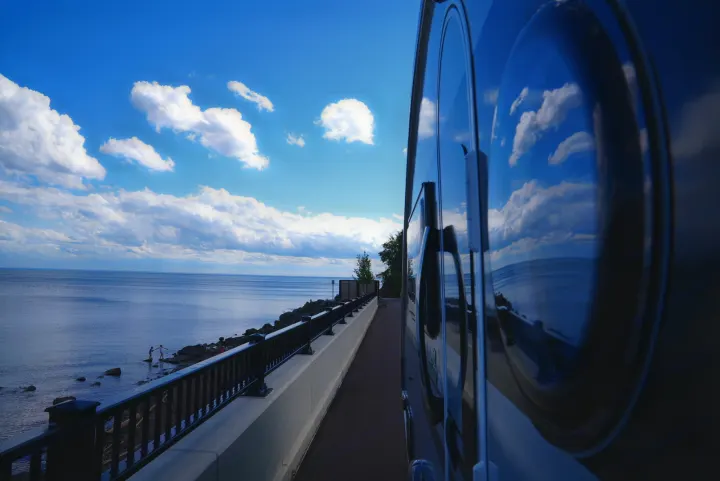 Enjoying a scenic waterfront view from an RV rental, with beautiful sky and clouds reflecting on its side.. Nucamp Tab 400 2022