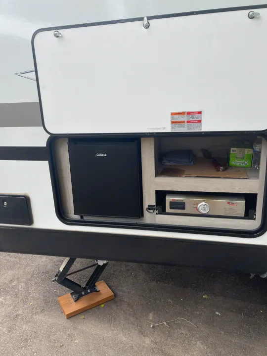 RV rental outdoor kitchen features a Galanz mini-fridge & Suburban griddle in an open compartment.. Connect SE 2021