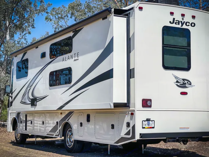 Jayco Alante RV rental parked at a sunny campsite with its slide-out extended, ready for travel.. Jayco Alante 29F 2023