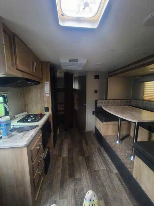 **RV rental** interior featuring a kitchen, dinette, and visible bunk beds, offering a complete mobile living space.. Coachmen Other 2021