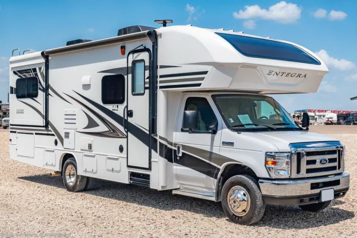 Bright white Entegra Odyssey Class C RV (Ford chassis) on a gravel lot, ready for your next rv rental adventure.. Entegra Coach Odyssey 2019