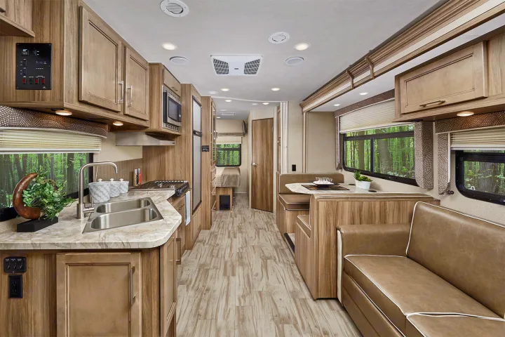 Modern RV rental interior showcasing a full kitchen, comfortable dinette, and living area, perfect for travel.. Entegra Coach Odyssey 2019