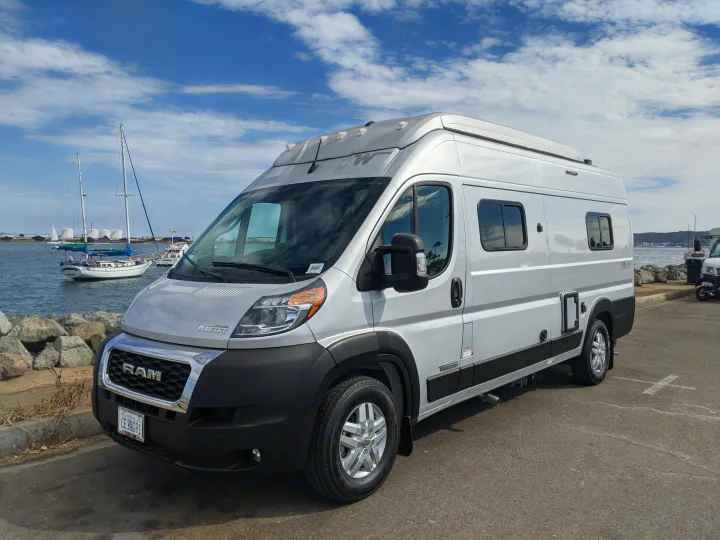 Silver Winnebago Solis rv rental parked by a marina, perfect for a California coastal adventure.. Winnebago Solis 2023