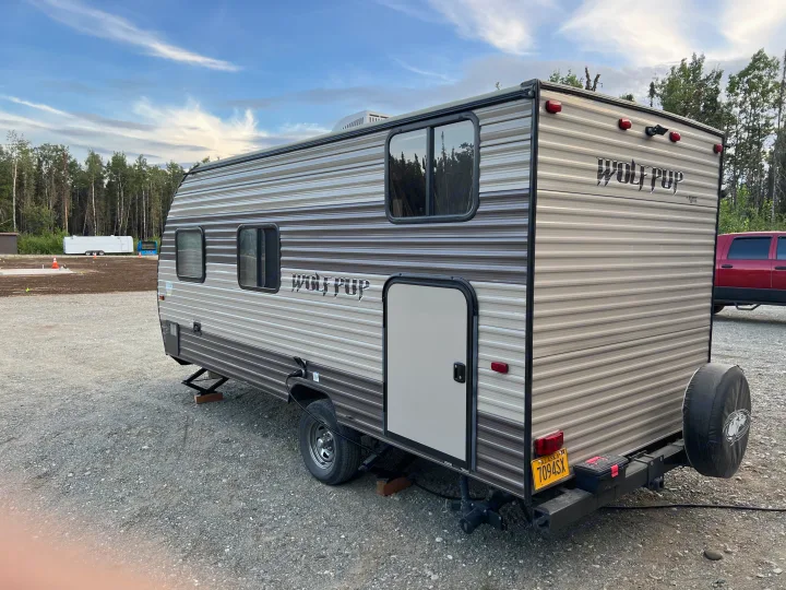 Modern Wolf Pup travel trailer RV rental, set up on gravel for your Alaska adventure.. Forest River Cherokee Wolf Pup 2018