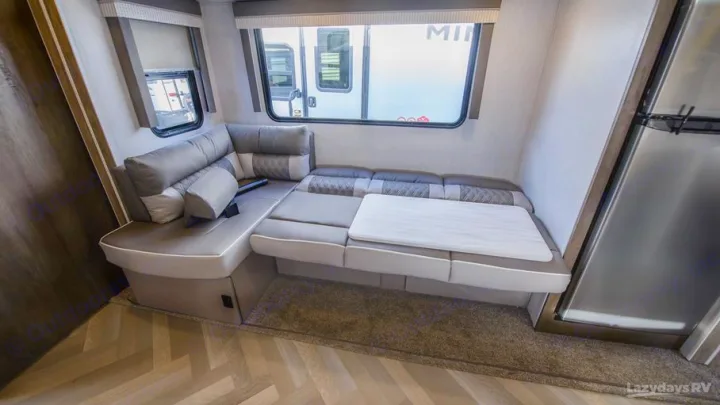 RV rental living space: Modern L-shaped dinette with table, perfect for comfort on your journey.. Forest River Wildwood 2022