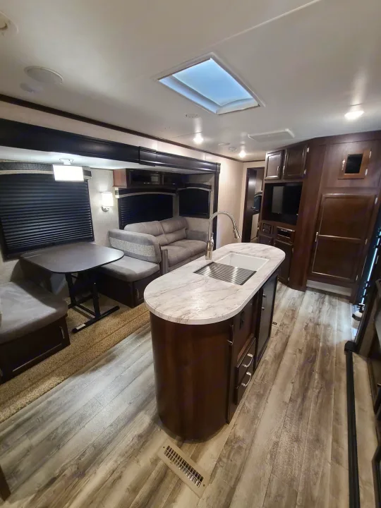 Spacious RV rental interior with kitchen island, dinette, and sofa. Modern & clean.. Jayco Jay Flight 2020