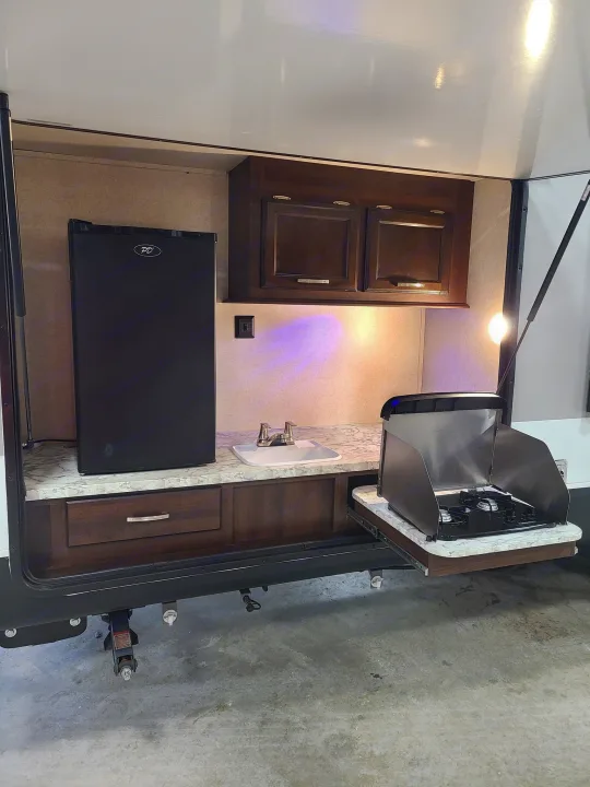 This RV rental's outdoor kitchen has a fridge, sink, and pull-out stove for easy cooking on your next adventure.. Jayco Jay Flight 2020