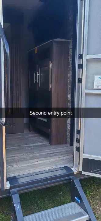 Inside this RV rental, a second entry point opens to a spacious interior with wooden floors & sturdy steps.. Forest River Cherokee Grey Wolf 2018