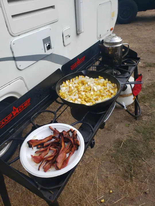 Enjoying a hearty breakfast at our RV rental campsite: bacon, potatoes, and coffee on a Camp Chef stove.. Clipper Clipper Trailer 2015
