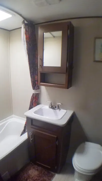 RV rental bathroom with tub, sink, toilet, & medicine cabinet.. Avenger ATI 2018