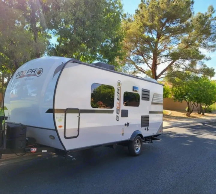 Modern white & gray Geo Pro travel trailer, an ideal RV rental for your next outdoor adventure, parked on a paved street.. Forest River Rockwood Geo Pro 2018