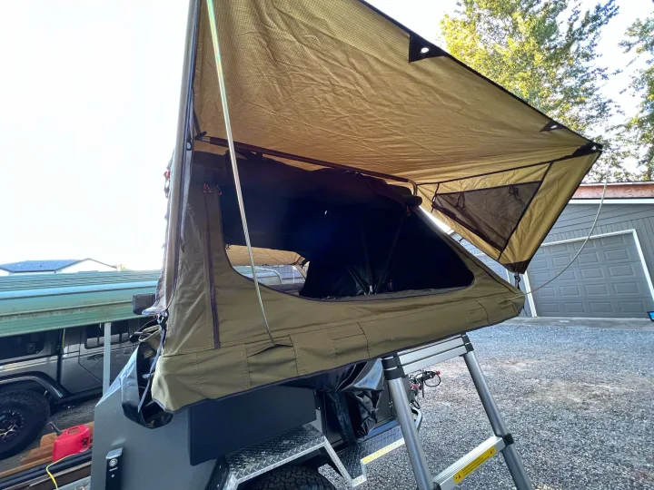 Open rooftop tent camper on a trailer with an awning and ladder, ideal for rv rental outdoor camping.. Vorsheer Vorsheer Trailer 2022