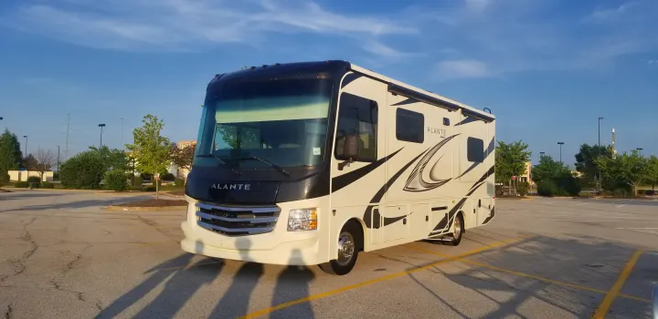 A cream and black Jayco Alante motorhome (RV rental) parked in a lot under a clear blue sky, ready for your next trip.. Jayco Alante 2021