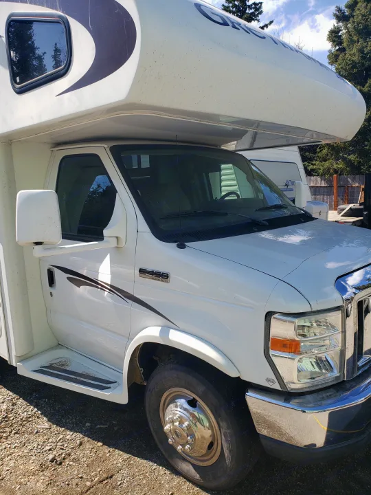 White Ford E-450 RV rental motorhome, front and side view. Parked outdoors.. Jayco Greyhawk 2011