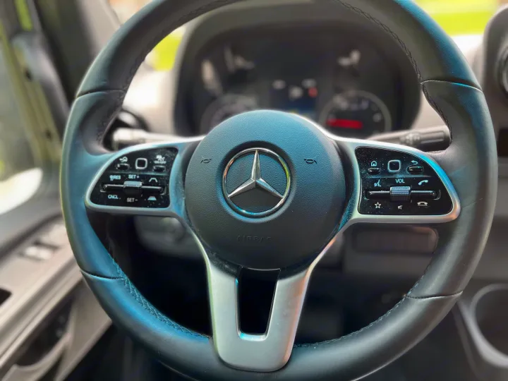 Modern Mercedes-Benz steering wheel with integrated controls, offering comfort for your rv rental adventure.. Mercedes Sprinter Motorhome Campervan RV 2021