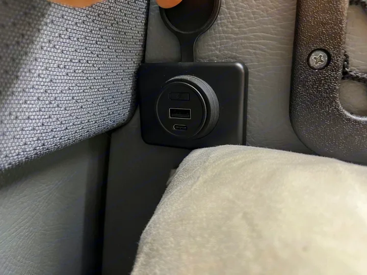 RV rental charging station: USB-A, USB-C, and a covered 12V outlet integrated into the vehicle interior.. Mercedes Sprinter Motorhome Campervan RV 2021