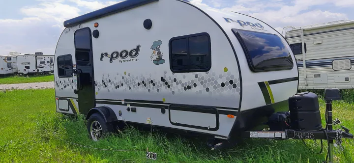 This r-pod travel trailer, available for RV rental, is parked on a grassy site, ready for your next outdoor adventure.. Forest River RPOD 190 2021