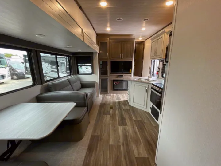 Step inside this modern RV rental! Features a comfy living area, functional kitchen, and dining booth. Ideal for travel.. Keystone RV Cougar 32BHS 2021