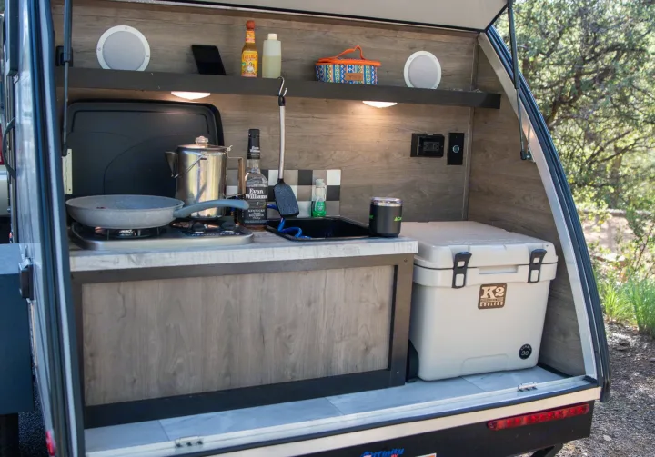 This RV rental's outdoor kitchen is ready for adventure! Features a stove, sink, and K2 cooler, perfect for camp meals.. Braxton Creek Free Solo 2022