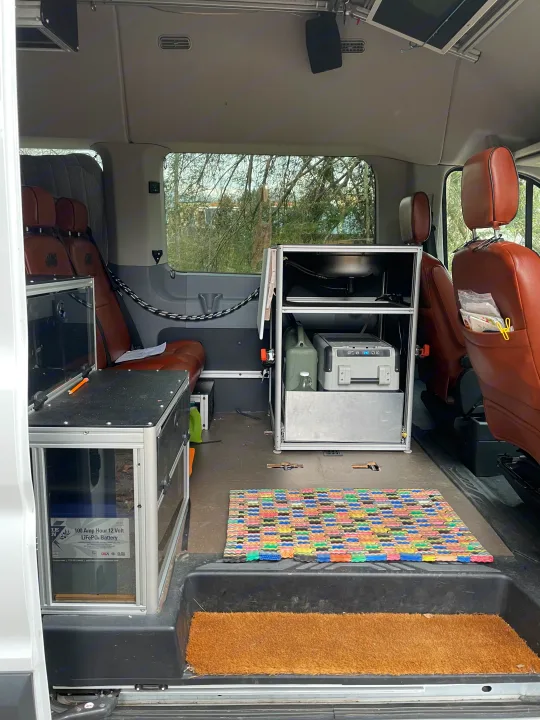 Custom camper van interior for RV rental: features kitchen, fridge, battery, seating, and overhead screen.. Vandoit Vandoit Class B 2017
