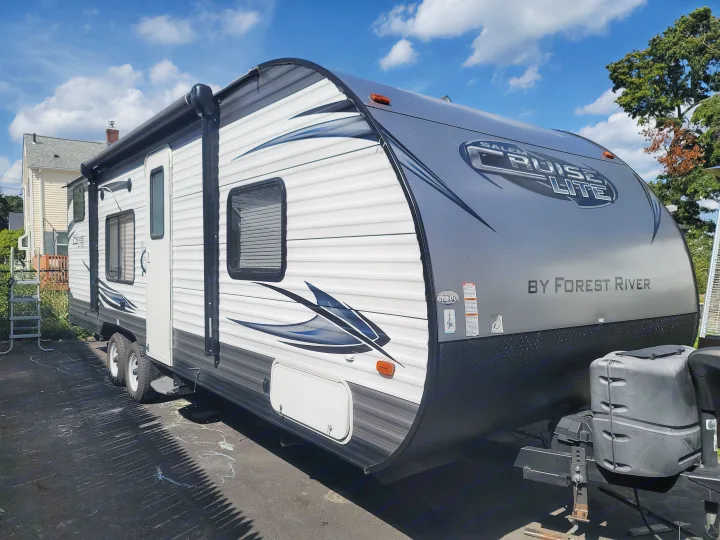 Salem Cruise Lite RV rental, a grey and white travel trailer parked outdoors for your next adventure.. Forest River Salem 2016