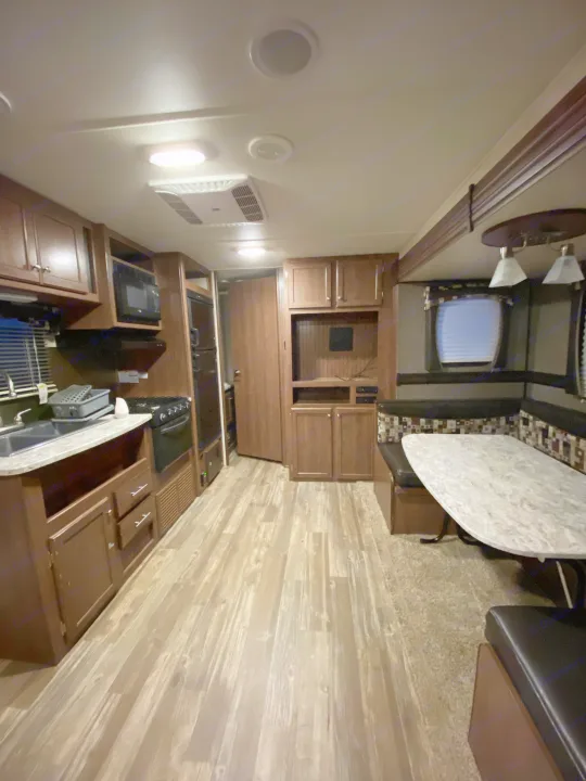 RV rental interior: full kitchen, dining booth, entertainment area. Modern design, ample storage.. Heartland RVs Pioneer Toy Hauler 2017