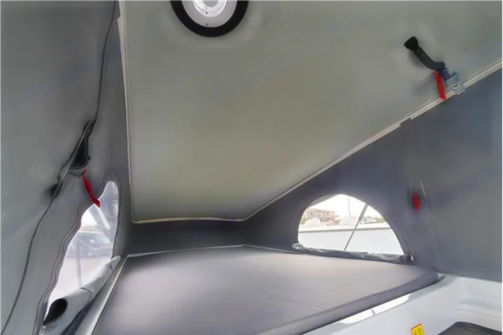 Explore your RV rental's pop-top sleeping area, featuring a comfortable bed, soft walls, and arched windows.. Winnebago Solis 2022