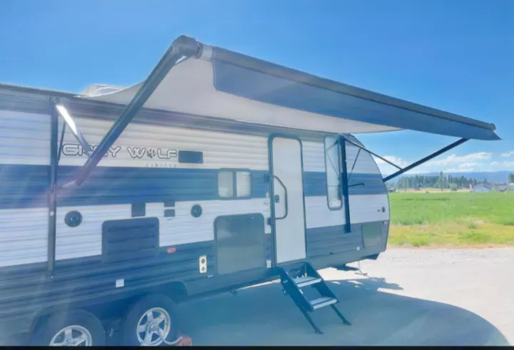 Spacious Grey Wolf travel trailer with extended awning & steps, ready for your RV rental getaway. Ideal for camping.. Forest River Cherokee Grey Wolf 2021