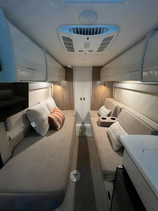 Spacious RV rental interior with comfortable benches convertible to beds, overhead storage, and AC for your next adventure.. Thor Other 2023