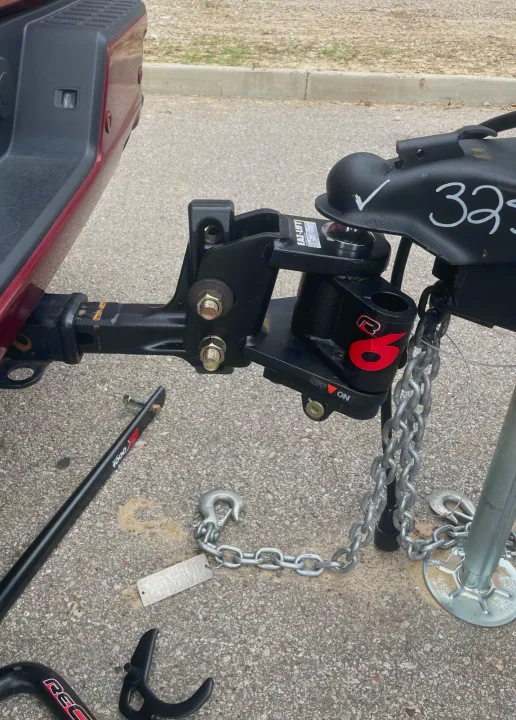RV rental hitch system: A weight distribution setup connects the truck receiver to the trailer coupler for stable towing.. Crossroads RV Volante 2022