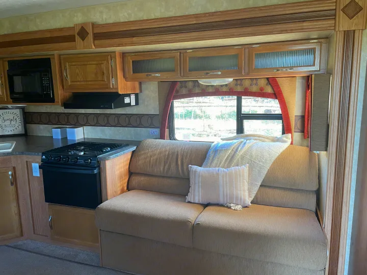 This RV rental features a well-equipped kitchen area, a comfortable dinette with a window, and ample storage.. Jayco Jay Feather Exp 2010