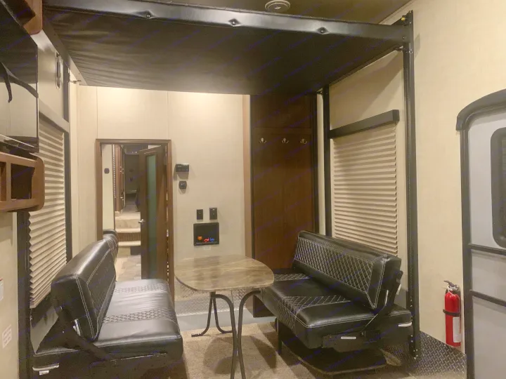 RV rental: Versatile garage space with convertible black benches, a dining table, and an overhead bunk system.. Keystone Fuzion 2015