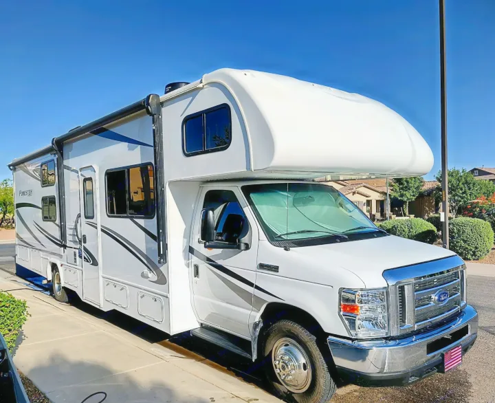Explore in this white and gray motorhome, perfect for an RV rental. Parked outside, ready for your road trip adventure!. Forester LE 2020