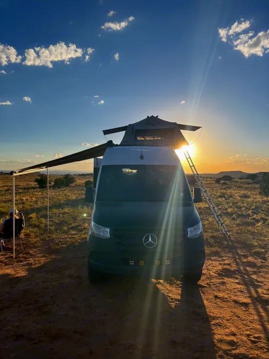 Off-grid RV rental: Mercedes Sprinter van, rooftop tent, and awning during a beautiful desert sunset.. Mercedes-Benz Sprinter 419 LWB High Roof 2022