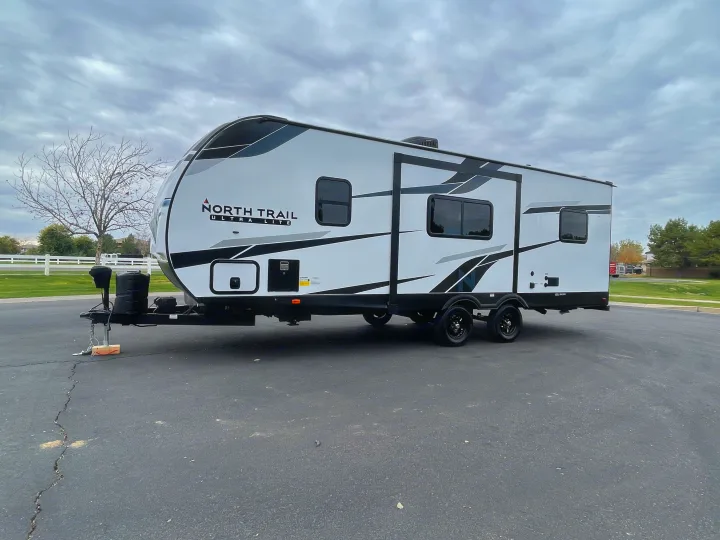 Modern North Trail Ultra Lite travel trailer parked, ideal for your next RV rental adventure.. Heartland North Trail 2022