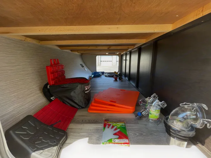 RV rental: Organized storage for camping essentials like leveling blocks, dump gloves, and clear sewer fittings.. Starcraft Super Lite 2022