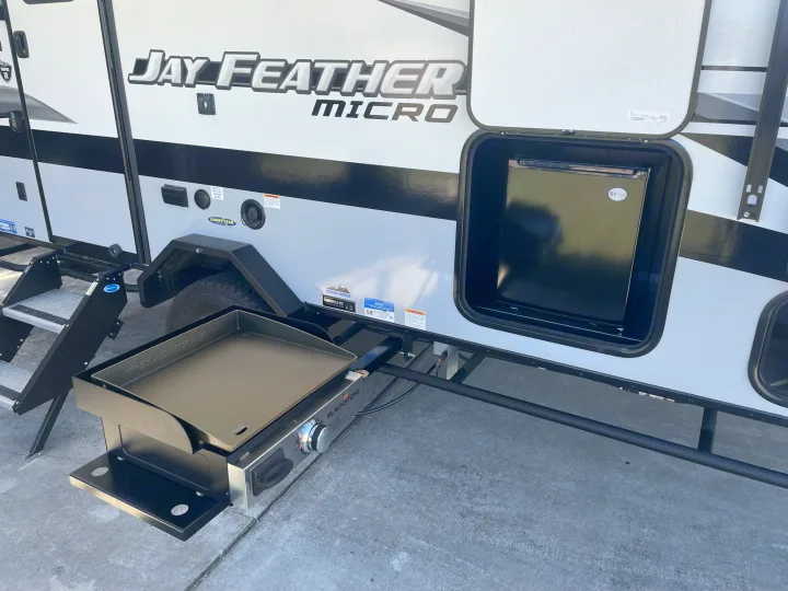 RV rental equipped for outdoor living: a side-mounted Blackstone griddle and an external fridge make campsite cooking easy.. Jayco Jay Feather Micro 2022