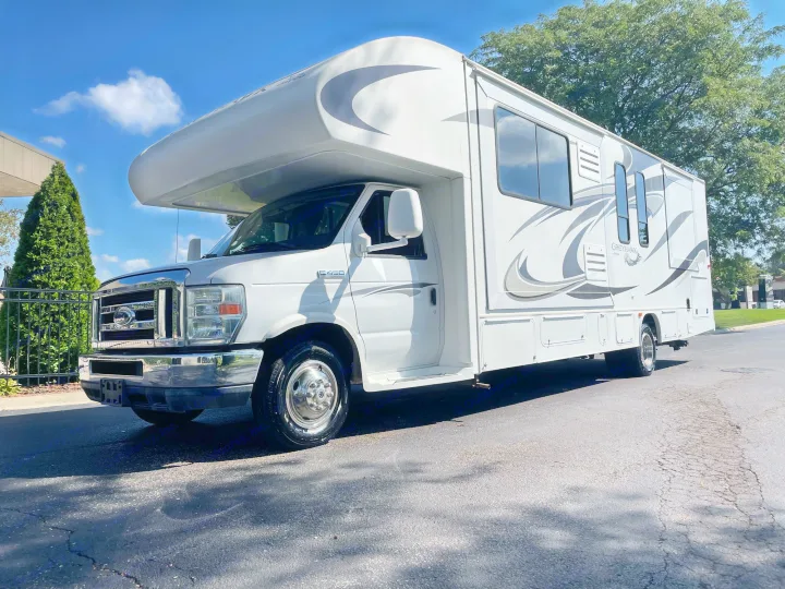A shiny white Jayco Greyhawk Class C RV rental is parked on a sunny day, ready for your next road trip adventure.. Jayco Greyhawk 2013