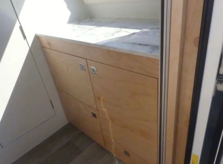 RV rental interior: modern light wood cabinets with a white countertop and efficient storage design.. Nucamp TAB 320 CS-S 2022