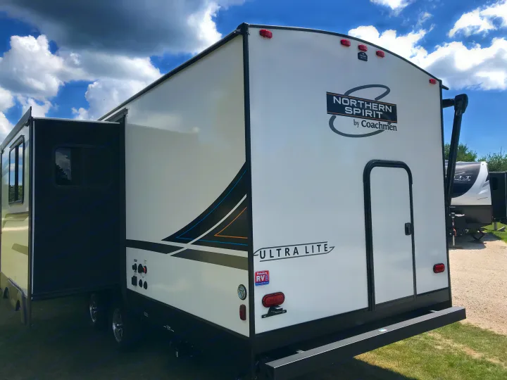 Northern Spirit Ultra Lite RV rental with extended slide-out, parked on grass at a campsite under a cloudy sky.. Other Other 2022