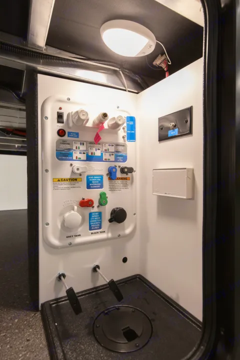 This RV rental utility bay shows detailed water connections, tank fill/dump controls for grey/black tanks, and winterization instructions.. Grand Design Reflection 2021