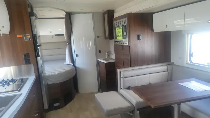 Spacious RV interior ready for travel. Features kitchen, dining, bed, and bath. Perfect for an rv rental vacation.. Winnebago Navion 2022