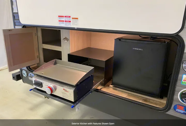 RV rental with an open exterior kitchen: slide-out griddle, mini-fridge, storage, & bottle opener for easy outdoor meals.. Forest River Coachmen Catalina Legacy 2022