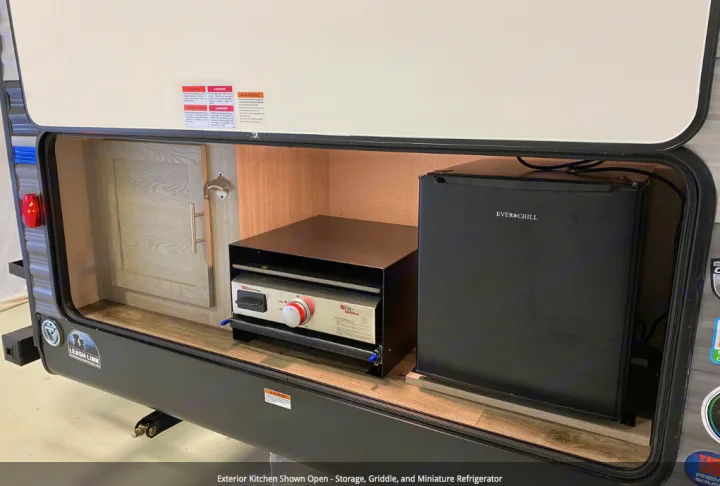 This RV rental offers an exterior kitchen with cabinet storage, a Cuisinart griddle, and an Ever Chill mini-fridge.. Forest River Coachmen Catalina Legacy 2022